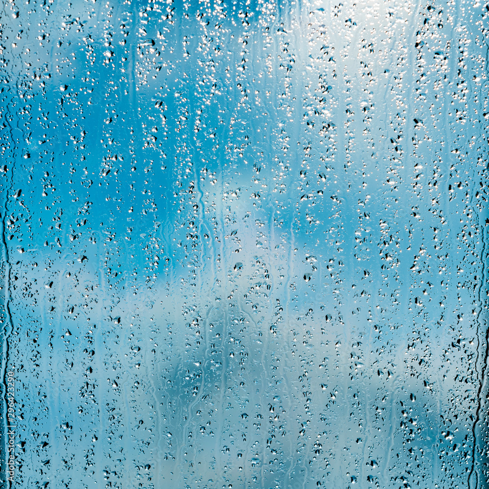heavy rain drops on blue window heavy rain drops on blue window