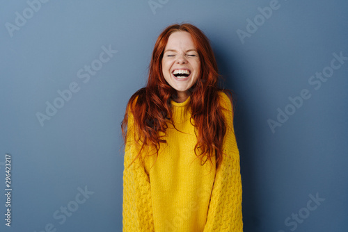 Quirky young woman screwing up her eyes photo