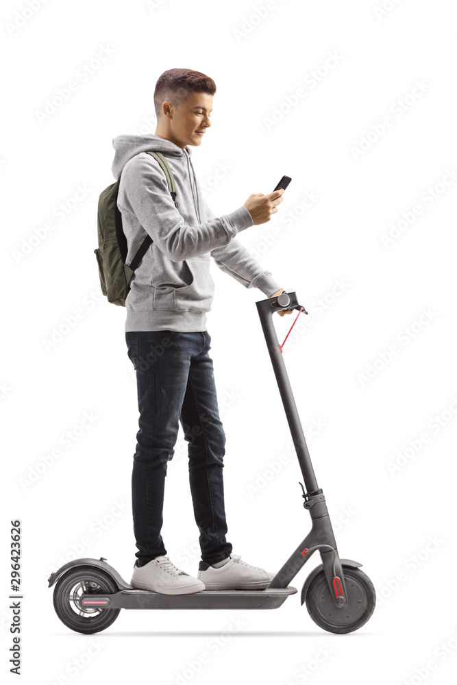 Male student with a backpack on an electric scooter using a mobile phone Male student with a backpack on an electric scooter using a mobile phone