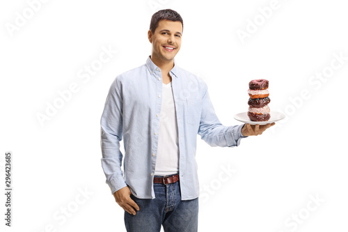 Young man holding a plate of donuts and smiling