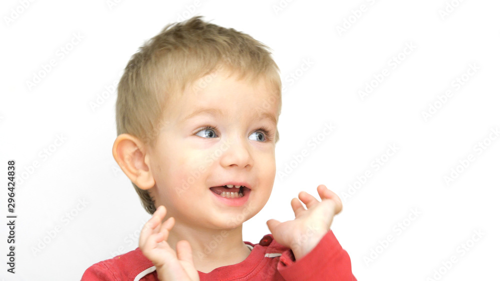 Portrait of funny little boy with blue eye playing with hands on face Portrait of funny little boy with blue eye playing with hands on face