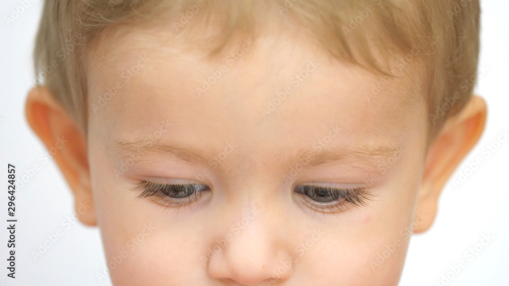 Portrait of little child with blue eyes looking down Portrait of little child with blue eyes looking down