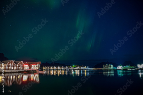 Traditional houses with northern lights in Lofoten, Norway