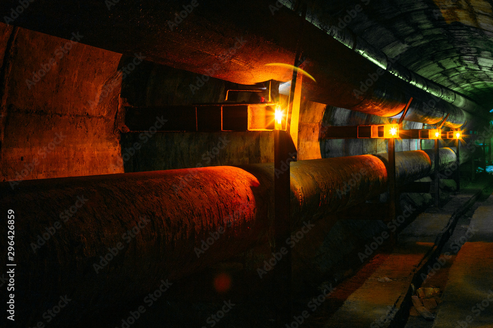 Rusty pipes in tunnel of heating duct system Rusty pipes in tunnel of heating duct system