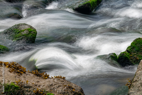 River Meavy water flowing over rocks at Lopwell Weir, Plymouth, Devon photo
