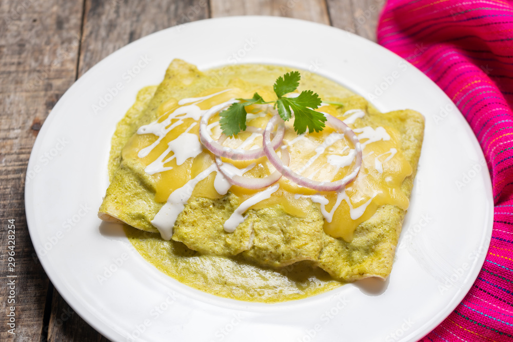 Mexican green enchiladas with melted cheese also called 