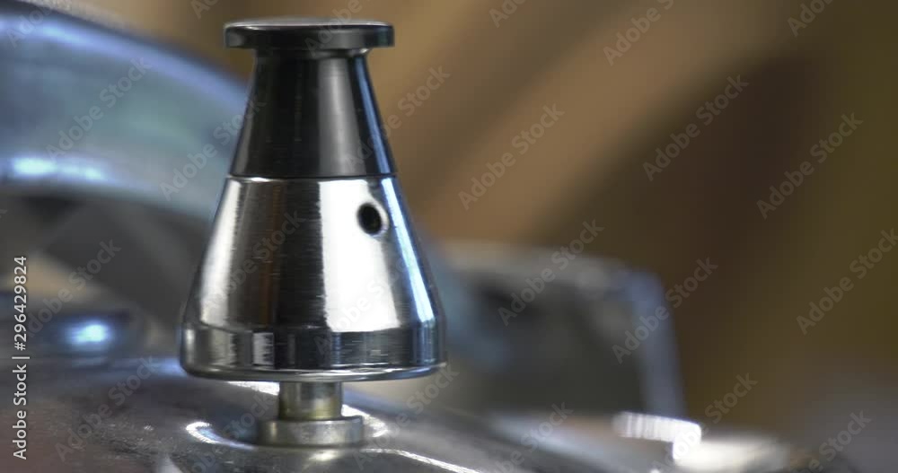Pressure cooker valve relieves pressure and rotates.Close-up of a rotary valve. Steam and water splashes out of holes. Pressure cooker valve relieves pressure and rotates.Close-up of a rotary valve. Steam and water splashes out of holes.