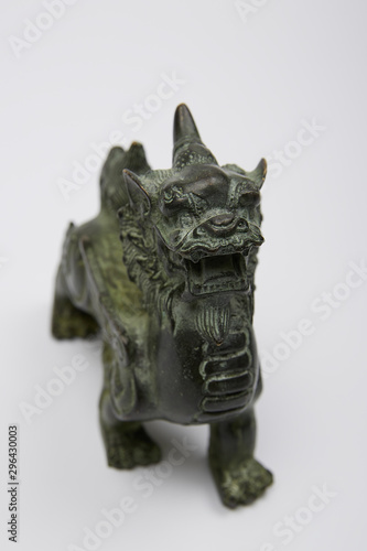 sculpture figurine dragon metal at background