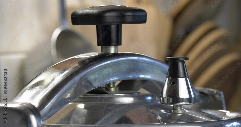 Pressure cooker valve relieves pressure and rotates.A medium shot of a rotary valve leaves steam and water spray out of the holes. Shallow depth of field. Pressure cooker valve relieves pressure and rotates.A medium shot of a rotary valve leaves steam and water spray out of the holes. Shallow depth of field.
