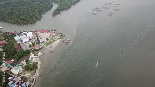 Aerial top down view boat moving toward fish farm at Tanjung Dawai, Kedah. photo