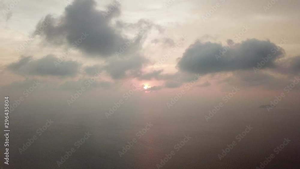 Aerial fly over the sea with orange cloud moving during sunset. Aerial fly over the sea with orange cloud moving during sunset.