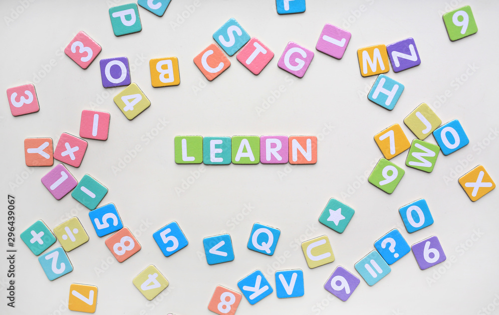 Multi-color Alphabet ABC letters and number and mathematics sign in square flat papers on white background with LEARN at center. Multi-color Alphabet ABC letters and number and mathematics sign in square flat papers on white background with LEARN at center.
