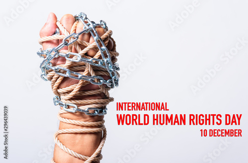 Obraz na plátně Rope and chain on fist hand with international world HUMAN RIGHTS DAY 10 decembe