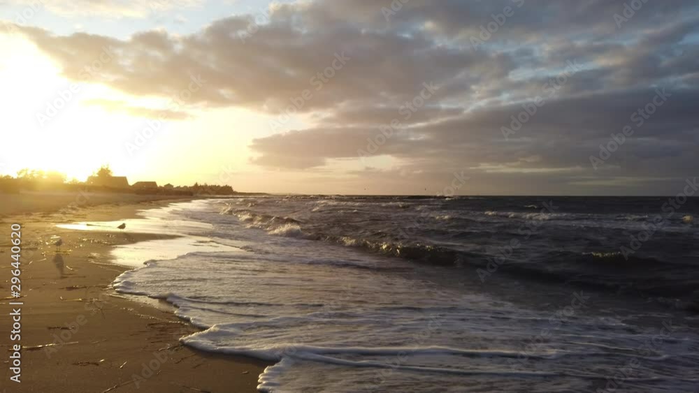 Golden waves surf at sandy beach in Probstei, slight panning movement to the right, 4k video Golden waves surf at sandy beach in Probstei, slight panning movement to the right, 4k video