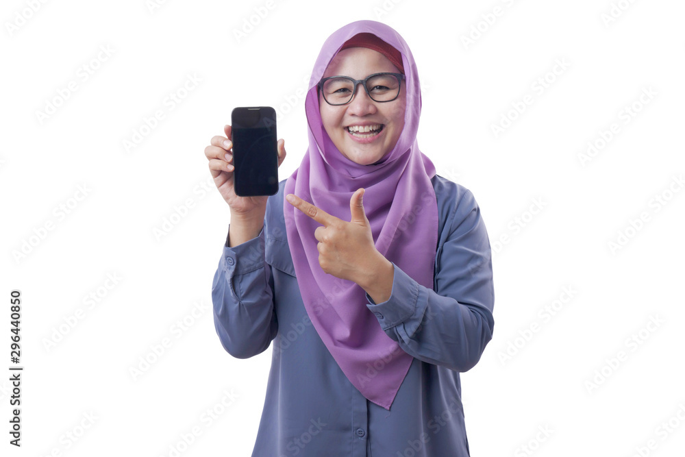 Muslim Woman Looking at Camera Smiling and Shows Smart Phone, Phone Mock Up Muslim Woman Looking at Camera Smiling and Shows Smart Phone, Phone Mock Up