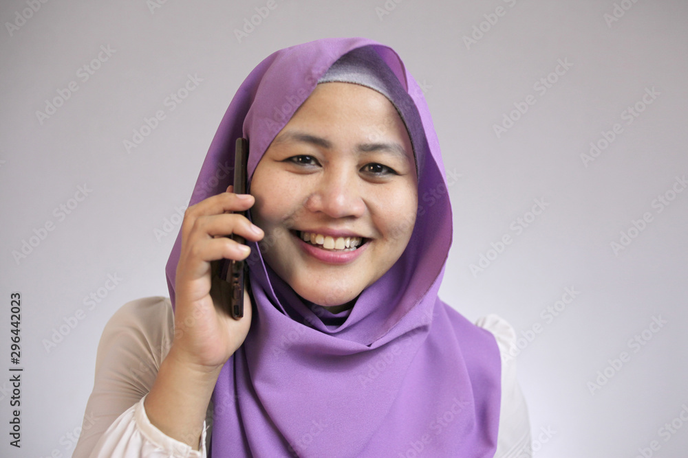 Muslim Lady Talking on Phone, Smiling Expression Muslim Lady Talking on Phone, Smiling Expression