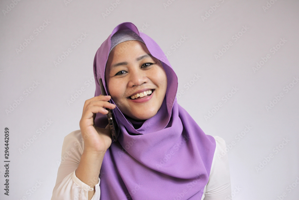 Muslim Lady Talking on Phone, Smiling Expression Muslim Lady Talking on Phone, Smiling Expression