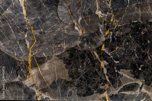 Black and gold marble texture stone background.