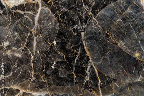 Black and gold marble texture stone background.
