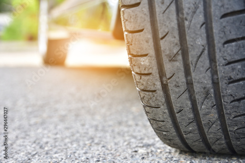 Car parked on street,Car on road and sunset background,Tire of car on road