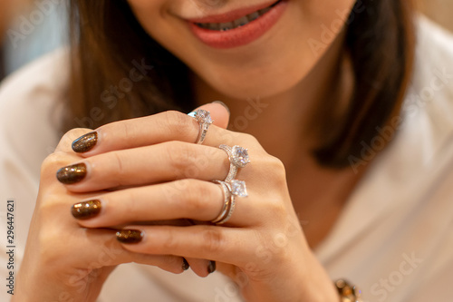 Close up of an elegant diamond rings on woman finger,(soft and sellective focus) photo
