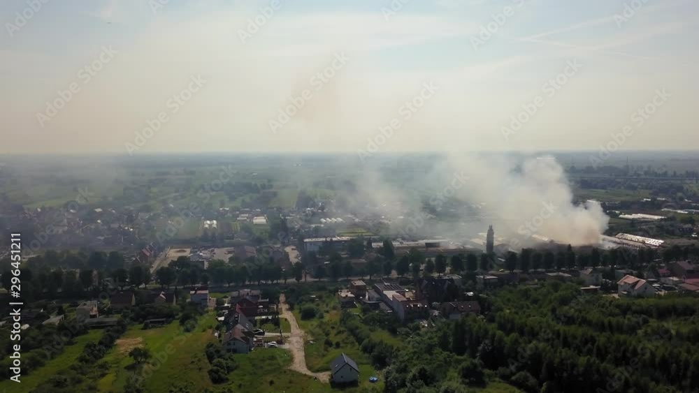 Aerial view of smoke from burning industrial building, fire in factory building. Aerial view of smoke from burning industrial building, fire in factory building.