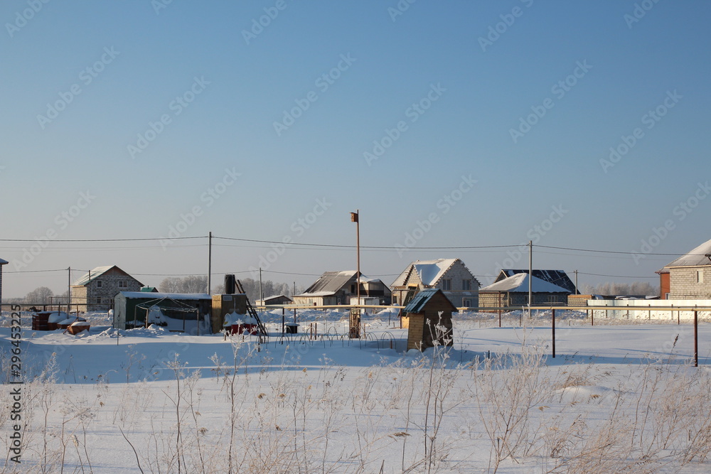 winter Siberian village with village houses with yards of wooden fences in the snow winter Siberian village with village houses with yards of wooden fences in the snow