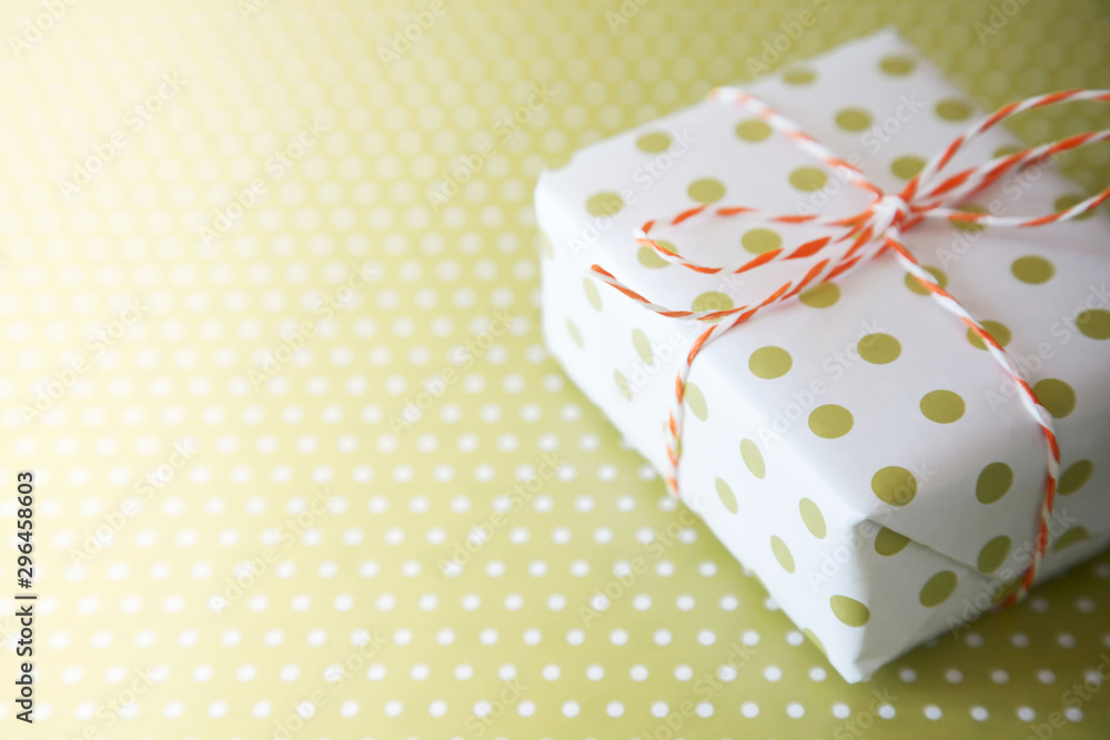Green gift with ribbon on the green polka dot background Green gift with ribbon on the green polka dot background