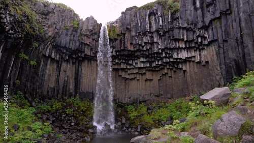 Slow motion: Extraordinary waterfall Svartifoss with volcanic basalt columns in Skaftafell 1080 HD photo