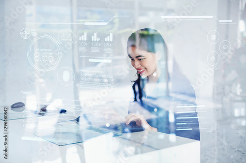 Asian woman using futuristic interface of a dashboard