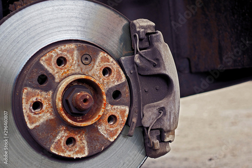 closeup of used car disc brake with caliper, color graded, focus on caliper