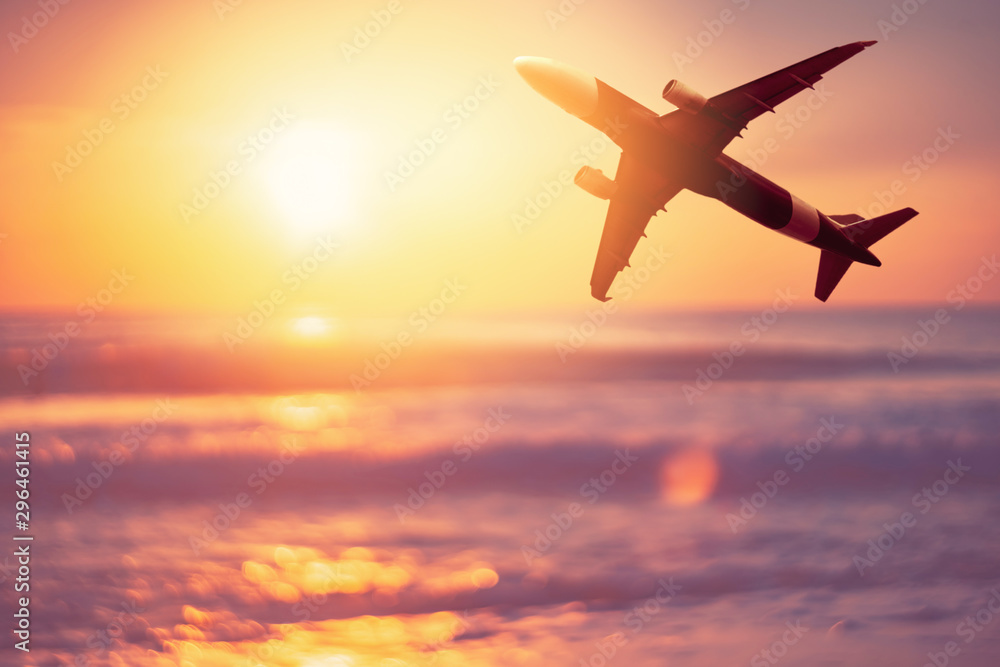 Airplane flying over tropical beach with smooth wave and sunset sky abstract background. Airplane flying over tropical beach with smooth wave and sunset sky abstract background.