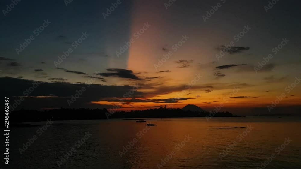 Slow motion panning video of a beautiful sunset with a volcano in the background Slow motion panning video of a beautiful sunset with a volcano in the background