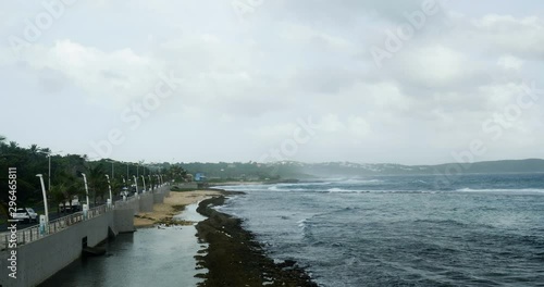 Wallpaper Mural dramatic view of a coastal road with cars. cloudy sky, wind, rocks and dark color sea. natural lighting for this seascape Torontodigital.ca