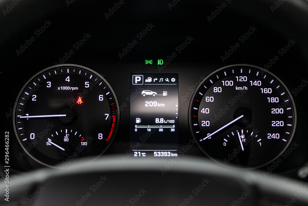 Car dashboard with white  backlight: Odometer, speedometer, tachometer, fuel level, water temperature and more.