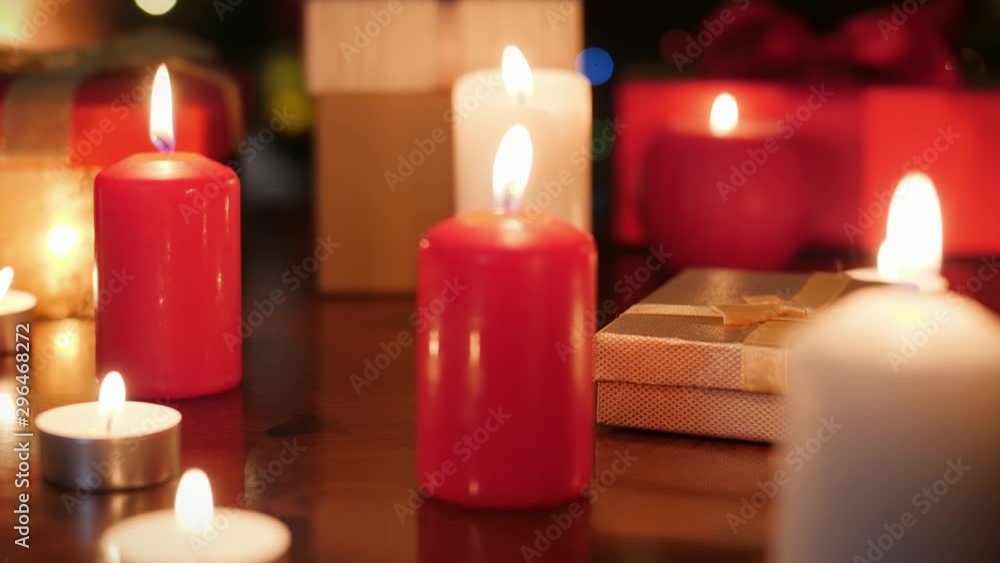 Dolly 4k video of lots of advent candles and boxes with Christmas gifts and present on wooden table. Perfect background or backdrop for Christmas or New Year Dolly 4k video of lots of advent candles and boxes with Christmas gifts and present on wooden table. Perfect background or backdrop for Christmas or New Year