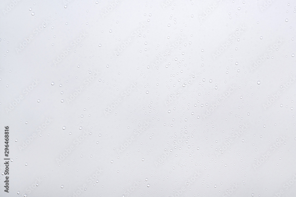 Naklejka premium Water drops on white surface background.