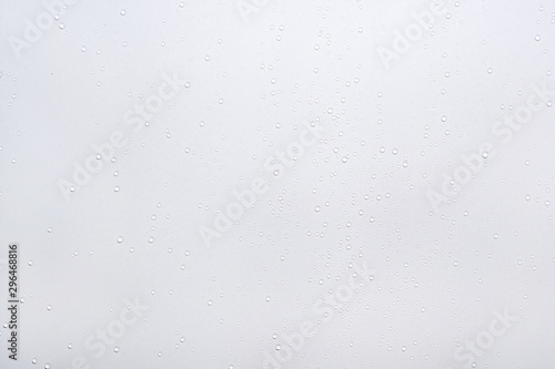 Water drops on white surface background.