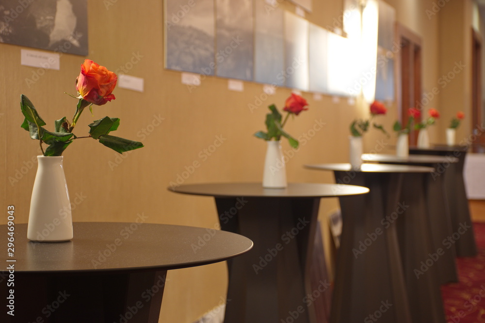 Red roses in white vase on the table