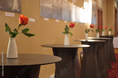 Red roses in white vase on the table