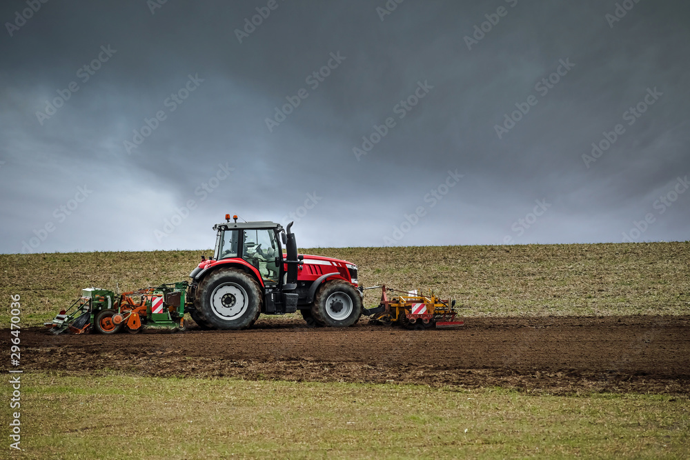 Fototapeta premium beautiful landscape with a farmer plowing his fields before the storm