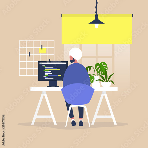 Tech industry, Young indian male web developer writing a code on a desktop computer in a modern office