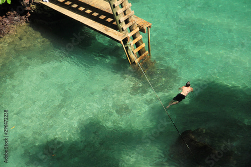 A man swimming in the To sua ocean trench photo