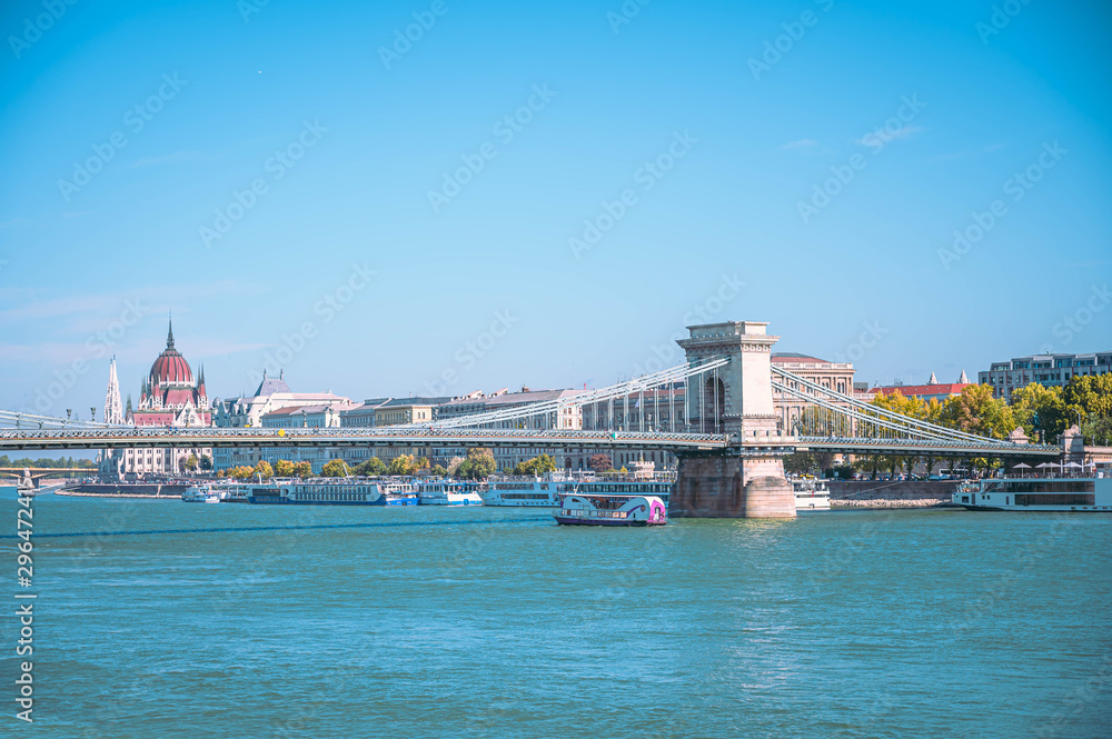 Bridge on Danube river in Budapest city. Hungary, Urban landscape panorama with old building and the famous Parliament building in Budapest in the background