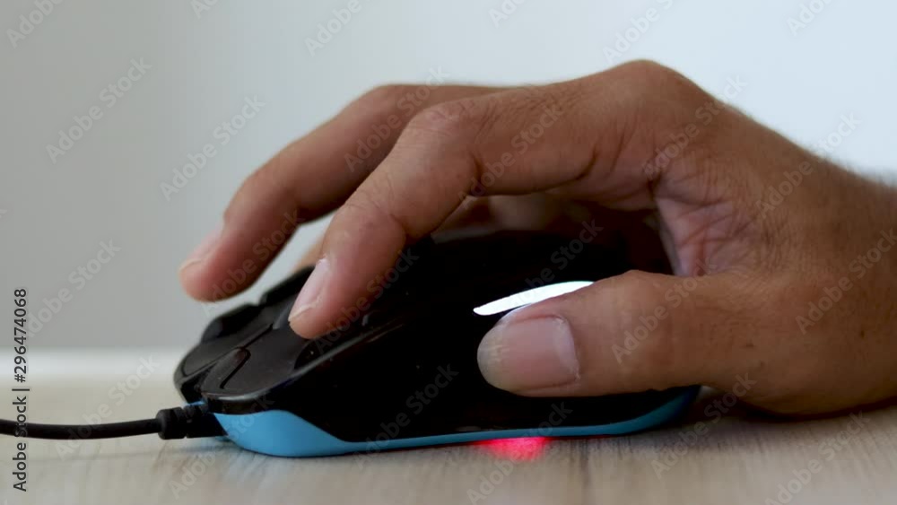 Closeup of man hand clicking computer mouse Closeup of man hand clicking computer mouse
