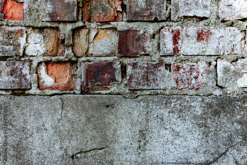 Texture of a brick wall with cracks and scratches which can be used as a background Texture of a brick wall with cracks and scratches which can be used as a background