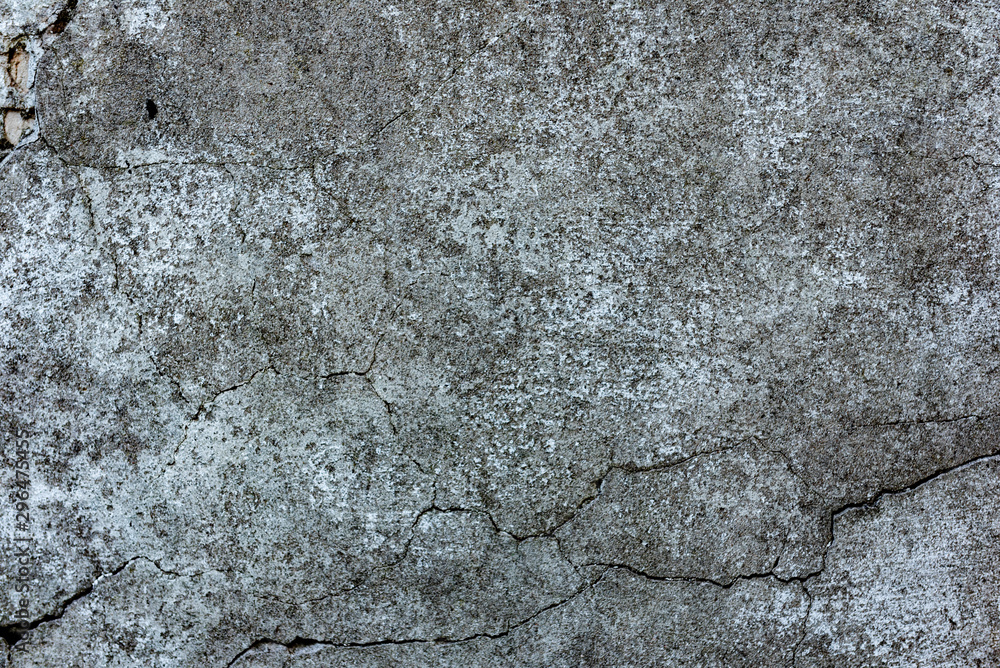 Texture of a concrete wall with cracks and scratches which can be used as a background Texture of a concrete wall with cracks and scratches which can be used as a background