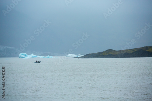 Summer time , Group of travellers take a boat to see the floating ice in the ocean icebergs in Jokulsarlon glacier lagoon, Iceland