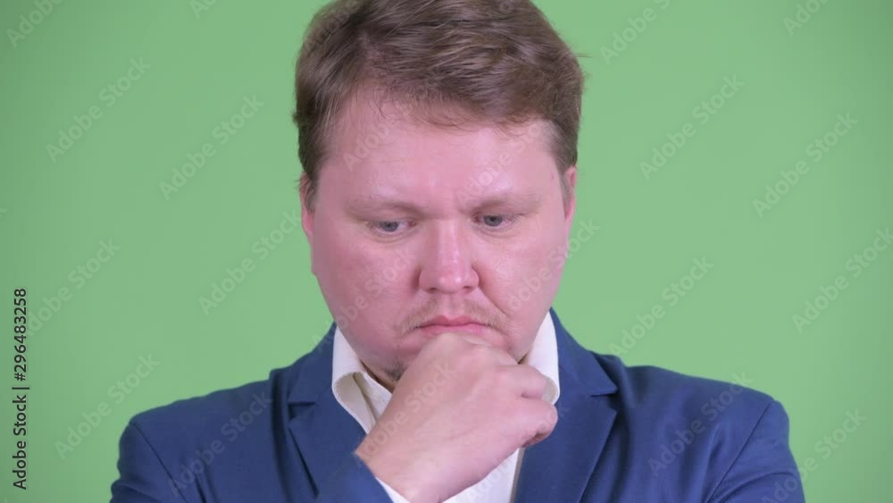 Face of stressed overweight bearded businessman thinking Face of stressed overweight bearded businessman thinking