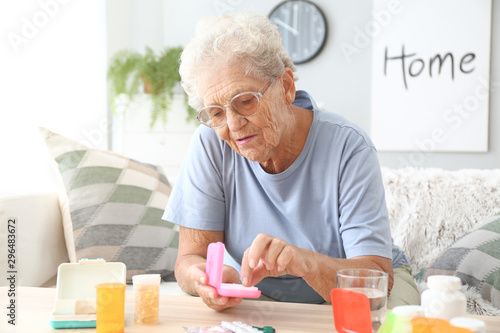 Elderly woman with medicine...